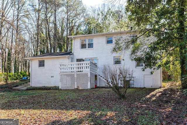 back of house with a deck