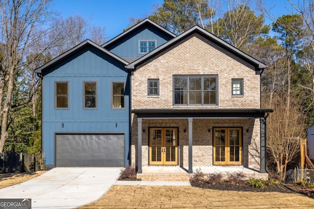 view of front of home with a garage and french doors