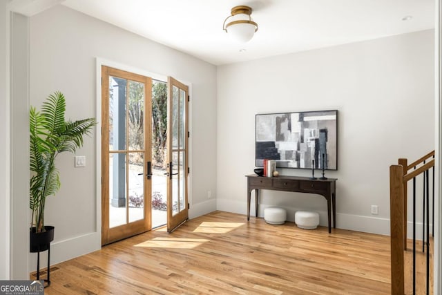 doorway with light wood-type flooring and french doors