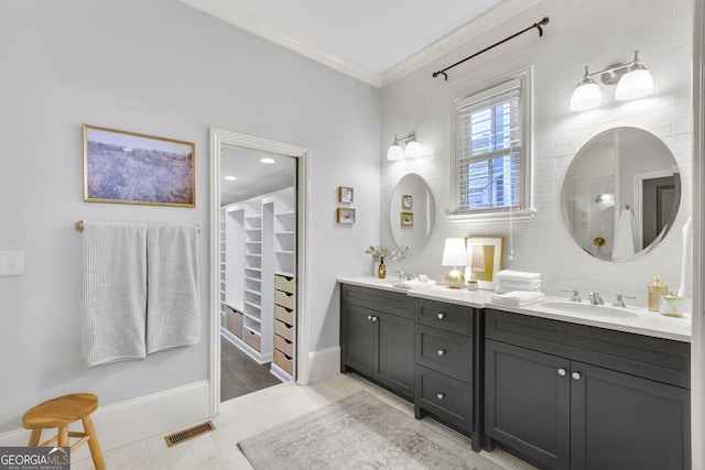 bathroom featuring vanity, tile patterned flooring, and crown molding