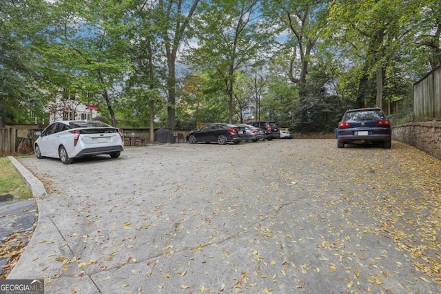 785 Ponce De Leon Pl NE Unit 8, Atlanta, GA 30306 - uncovered parking lot featuring view of wooded area