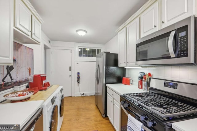 785 Ponce De Leon Pl NE Unit 8, Atlanta, GA 30306 - kitchen with appliances with stainless steel finishes, light countertops, white cabinets, and light wood-style flooring