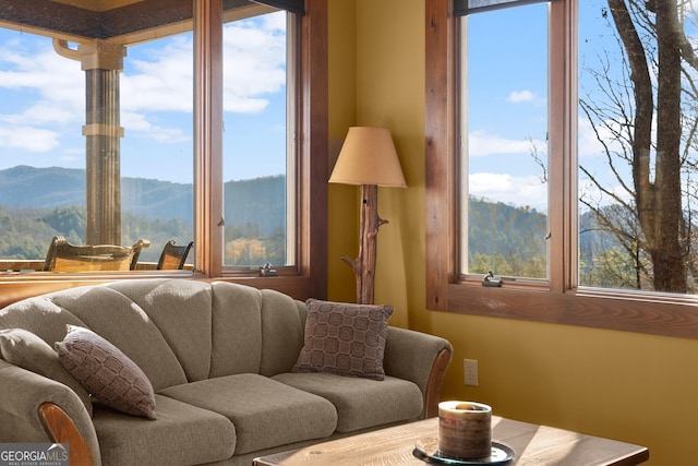 living room featuring a mountain view and a wealth of natural light