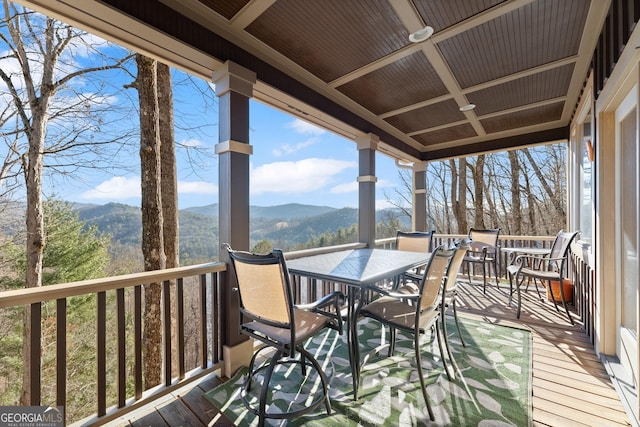 wooden deck with a mountain view