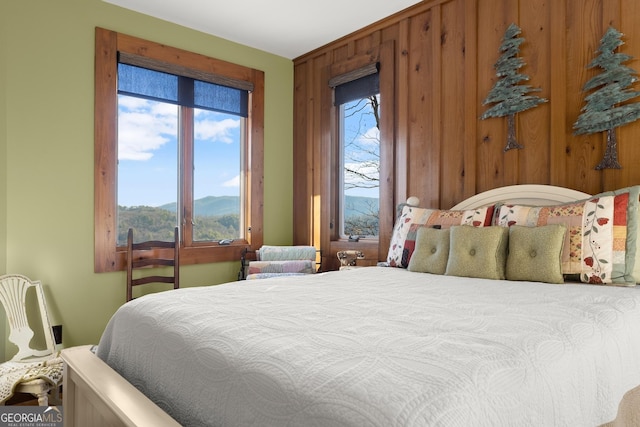 bedroom with a mountain view and wooden walls