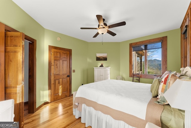 bedroom with light wood-type flooring and ceiling fan