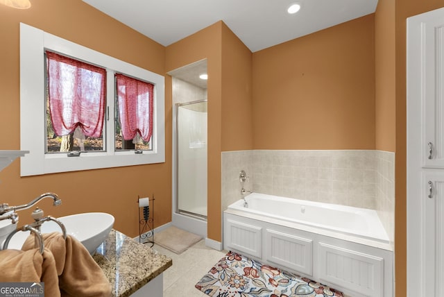 bathroom with sink, independent shower and bath, and tile patterned flooring