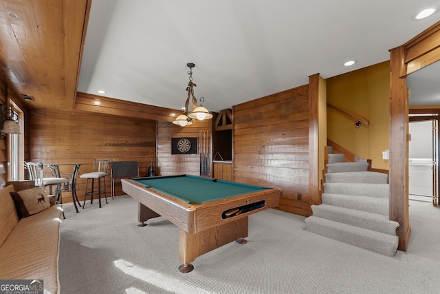 rec room with billiards, light carpet, and wood walls