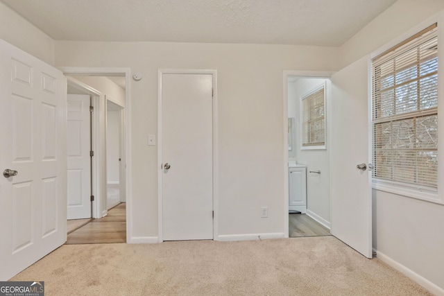 unfurnished bedroom featuring light carpet