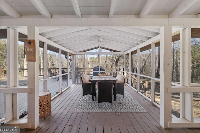 sunroom featuring lofted ceiling