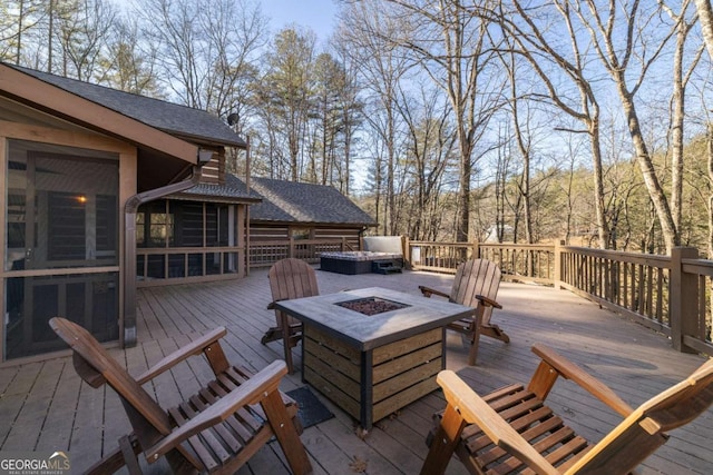 wooden terrace featuring a fire pit