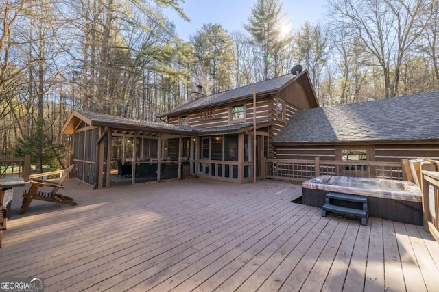 wooden terrace with a sunroom and a hot tub