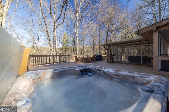 view of pool featuring a sunroom and a hot tub