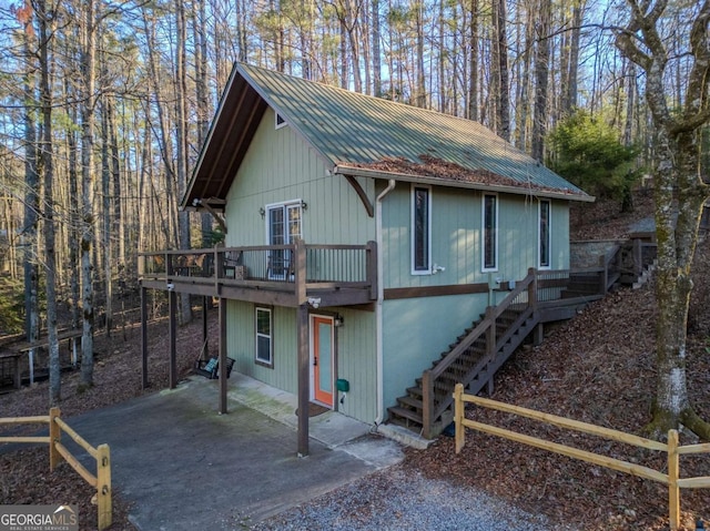 view of front of home with a wooden deck and a patio area