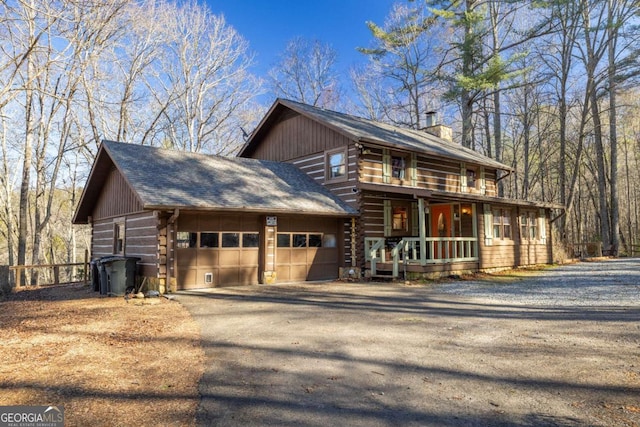 view of front facade with covered porch and a garage