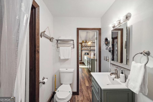 bathroom featuring hardwood / wood-style floors, toilet, and vanity