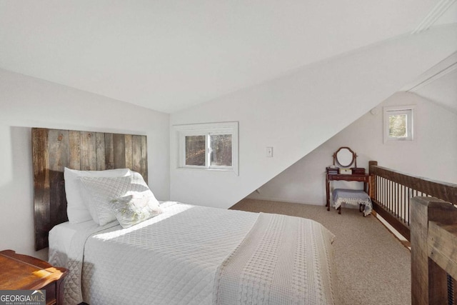 carpeted bedroom featuring lofted ceiling