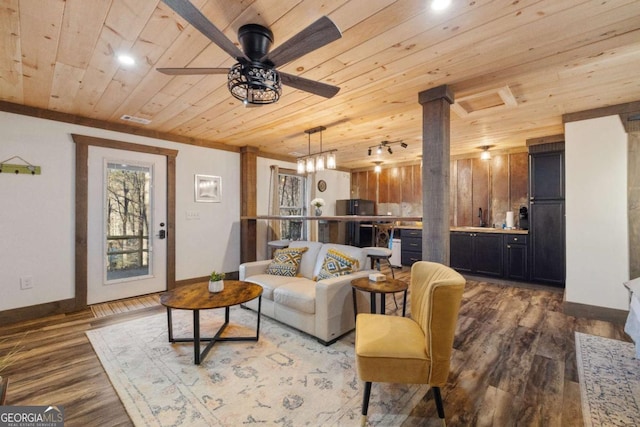 living room featuring wooden ceiling, sink, ornamental molding, dark wood-type flooring, and ceiling fan