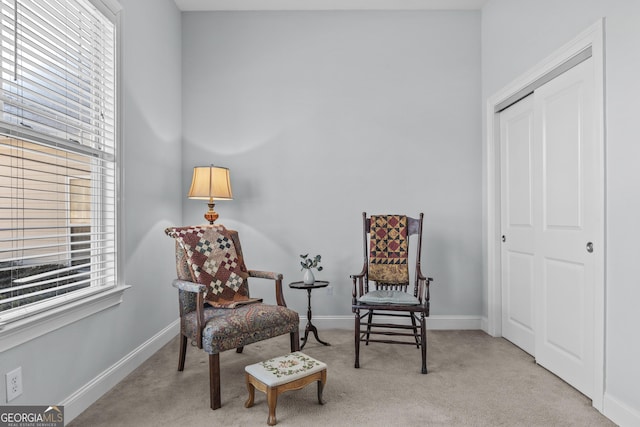 sitting room featuring light colored carpet