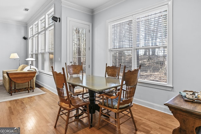 dining area with light hardwood / wood-style flooring and a wealth of natural light