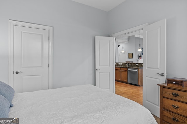 bedroom with light wood-type flooring and a closet