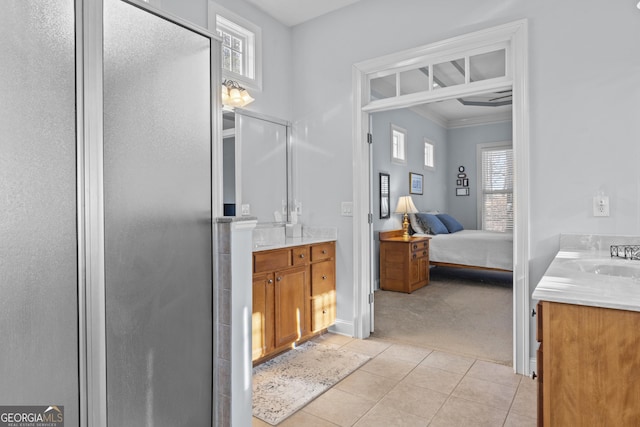 bathroom with sink, a wealth of natural light, a shower with door, and tile patterned flooring