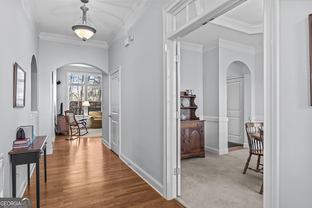 corridor featuring light carpet and ornamental molding