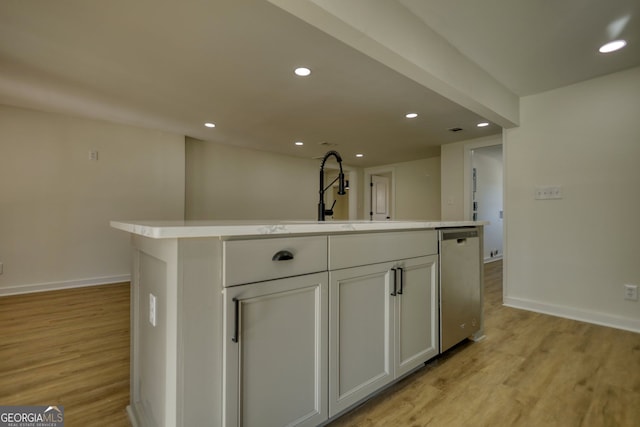 kitchen featuring dishwasher, light countertops, light wood-style flooring, and recessed lighting