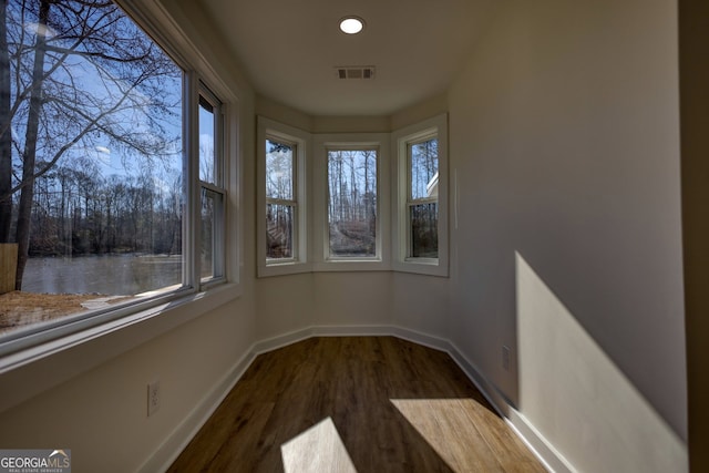 unfurnished sunroom with visible vents