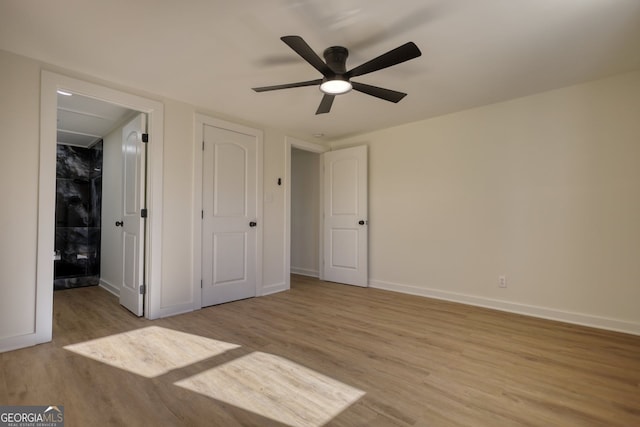 unfurnished bedroom with light wood-style flooring, a ceiling fan, and baseboards