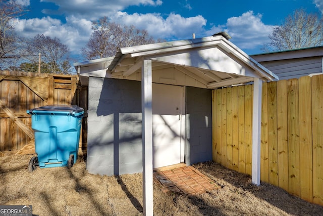 view of outdoor structure with an outbuilding and fence