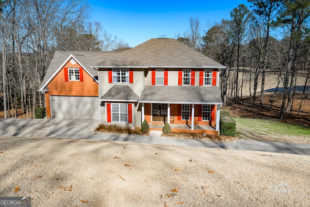 view of front of house featuring covered porch and a garage