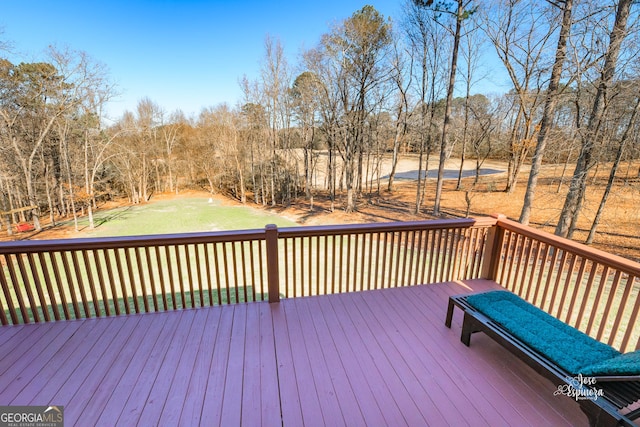 wooden terrace with a lawn