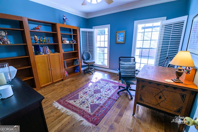 home office with ceiling fan, hardwood / wood-style floors, and crown molding