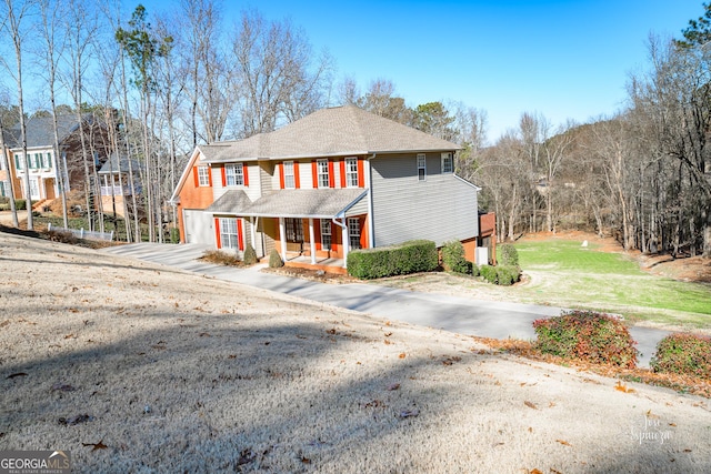 view of front of property with a porch and a front lawn