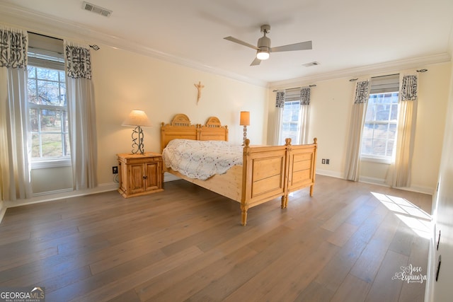 bedroom featuring crown molding and dark hardwood / wood-style floors