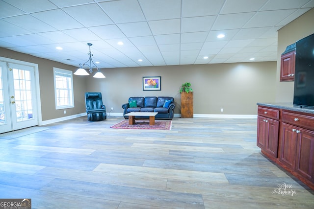 living room featuring light hardwood / wood-style floors and french doors