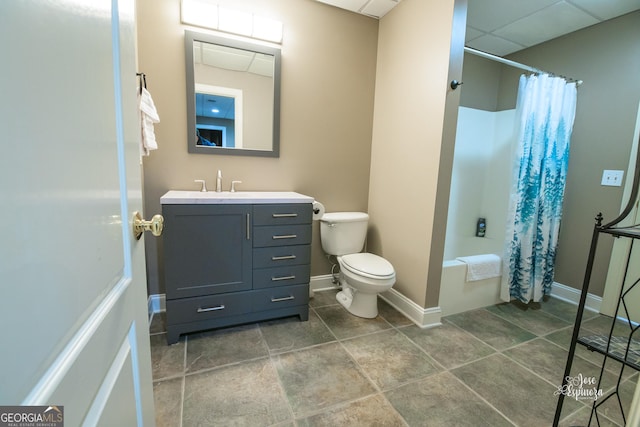 full bathroom featuring vanity, a paneled ceiling, toilet, and shower / bath combo with shower curtain