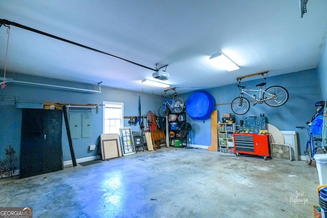 garage with a garage door opener and a workshop area