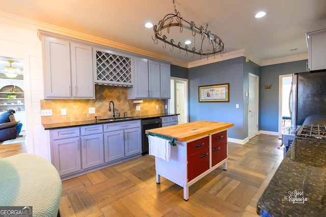 kitchen with crown molding, dishwasher, stainless steel fridge, wooden counters, and sink