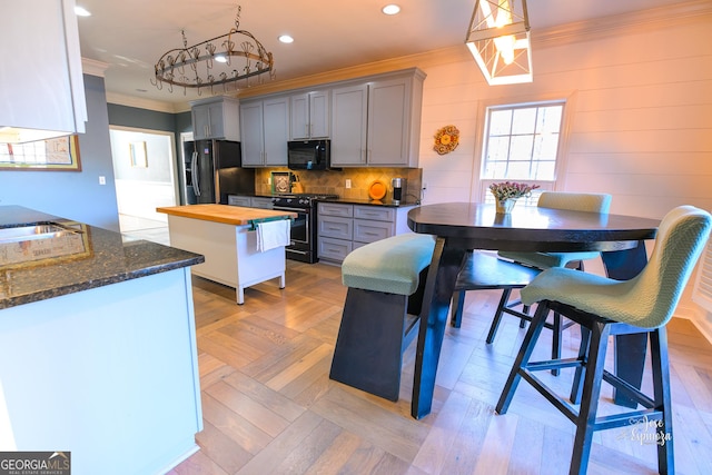 kitchen with crown molding, pendant lighting, wooden counters, gray cabinetry, and black appliances