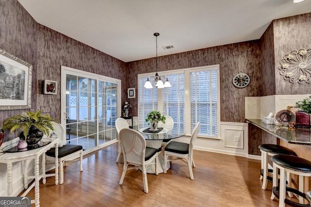 dining room featuring light wood-type flooring and a notable chandelier