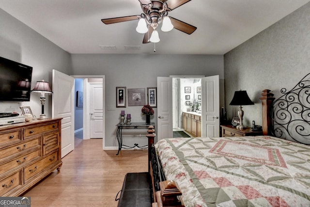 bedroom featuring light hardwood / wood-style flooring, connected bathroom, and ceiling fan