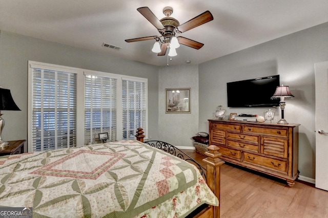 bedroom with ceiling fan and light hardwood / wood-style flooring