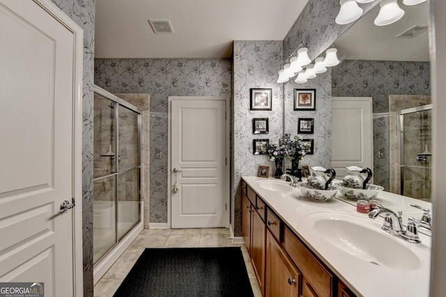 bathroom featuring a shower with door, tile patterned floors, and vanity