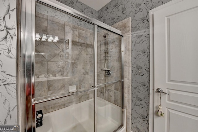 bathroom featuring bath / shower combo with glass door