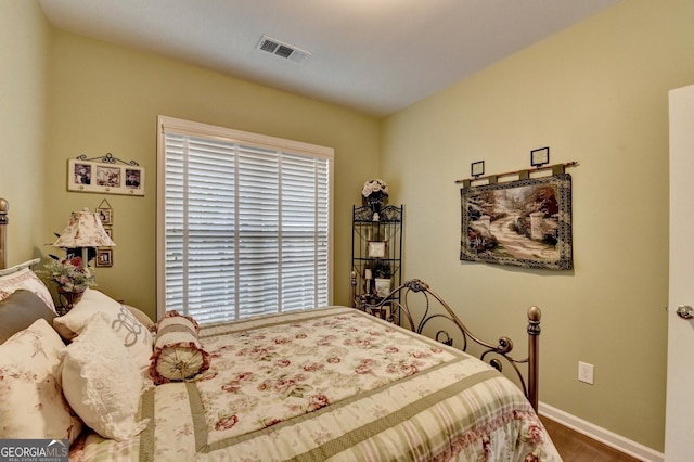 bedroom with hardwood / wood-style floors