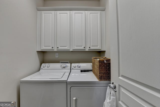 laundry room with cabinets and separate washer and dryer