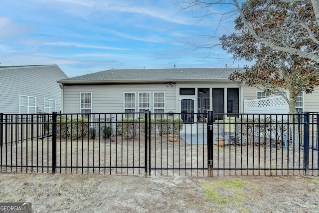 back of property with a sunroom