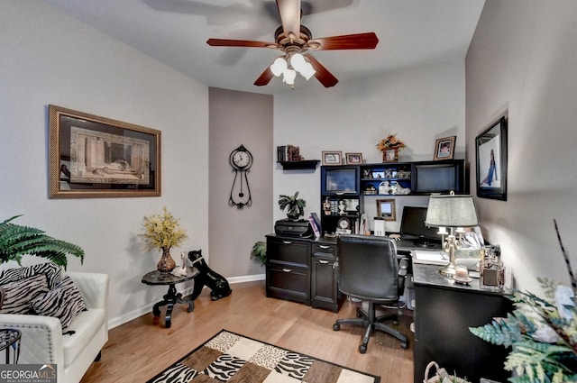 home office with light wood-type flooring and ceiling fan